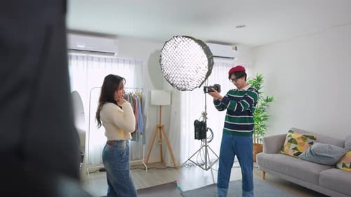 Asian beautiful woman model and cameraman working in photography studio.