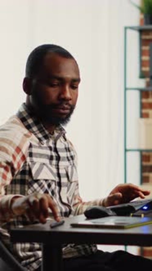 Man Working at Desk in Office on Tablet
