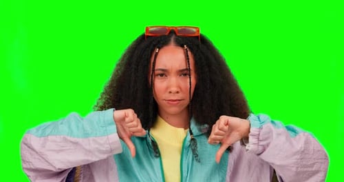 Young woman, thumbs down and disagree by green screen with symbol, icon or sign language in mockup