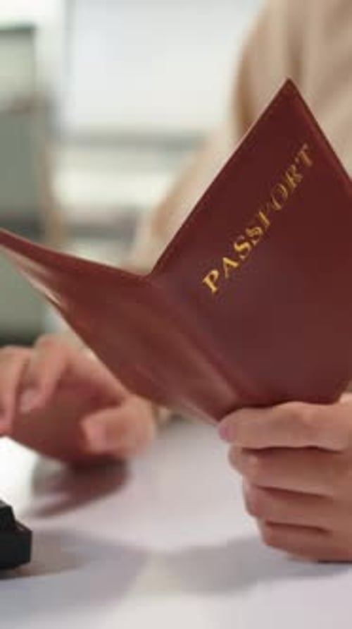 Unrecognizable Manager Checking Passport of Client
