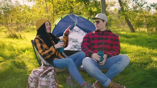 Young Couple Camping in Sunny Forest