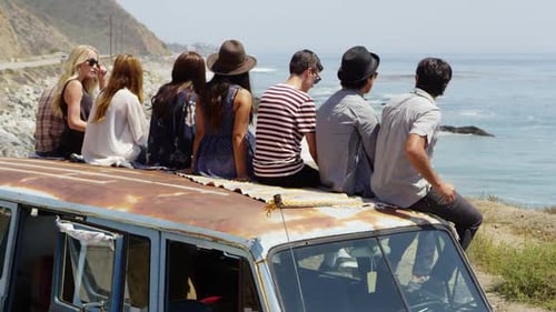 Young Adults on an Old Van Overlooking the Ocean