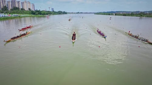 Dragon Boat team rowing to the pace of an onboard Drummer.