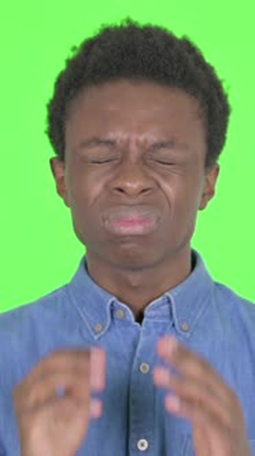 Young African Man Having Headache on Green Background, Vertical Video