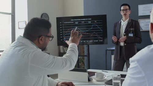 Businesswoman Giving Presentation to Colleagues in Office