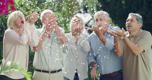 Happy Adults Celebrate with Confetti in Garden Setting