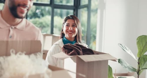 Smiling Couple Unpacking Boxes in New Home