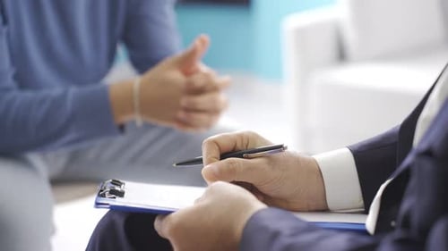Therapist Writes Notes During Patient Consultation