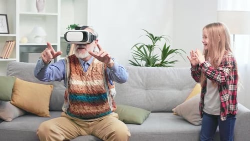 Grandfather Enjoys Virtual Reality with Granddaughter