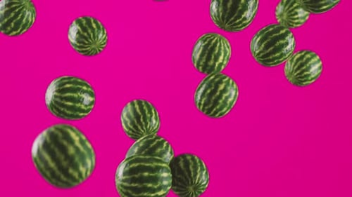 Seamless Loop of Falling Watermelons on Vibrant Pink Background