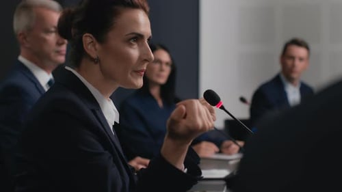 Confident businesswoman delivers speech at political conference in convention hall