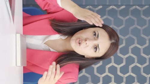 Young Woman Giving Business Presentation at Desk
