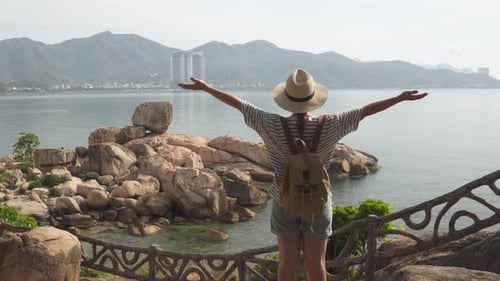 Woman Traveler Admiring Coastal Landscape