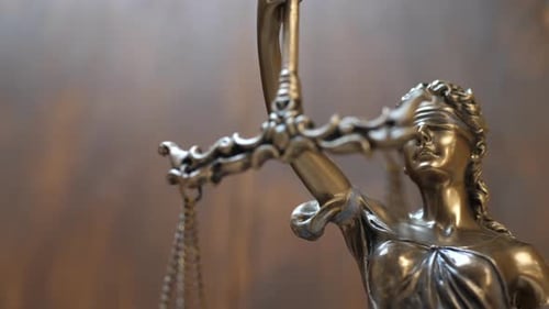 Artistic close-up of bronze Lady Justice statue