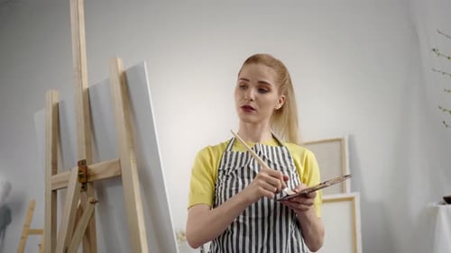 Young Adult Female Artist Drawing Picture By Oil Dyes in Art Studio Portrait Professional Painter or