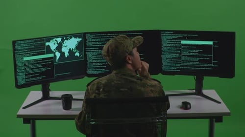 Back View Of Man Soldier Developer Thinking While Write Code With Multiple Screens In Green Screen