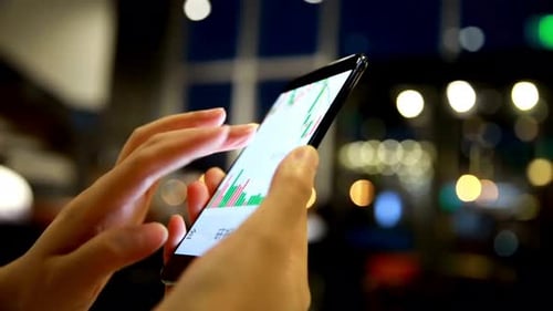 Stock Data Analysis on Smartphone Screen, Blurred Background