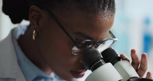 Woman Scientist Working with Microscope in Lab