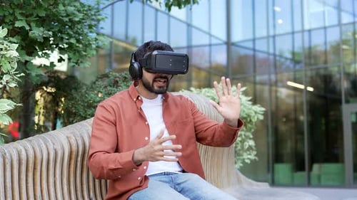 Young Adult Using VR Headset on Bench