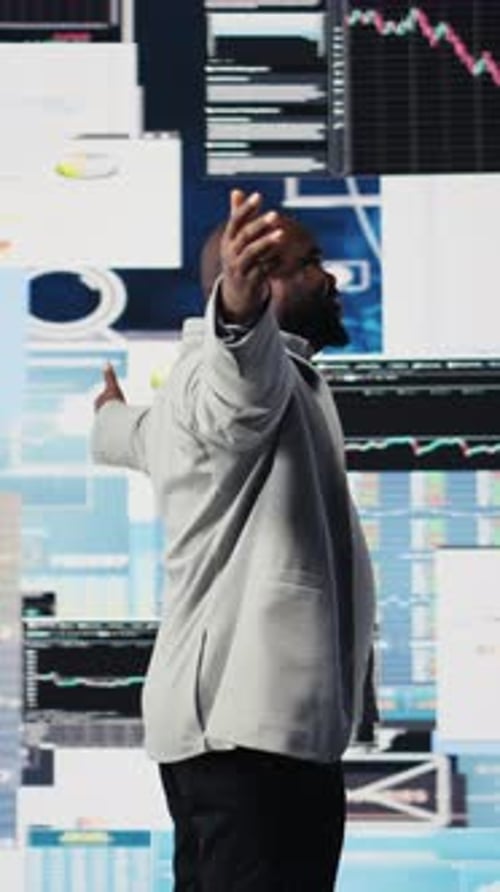 Man Celebrates Success in Front of Computer Monitors