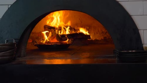 Wood Fire Burning with Flames in Brick Oven