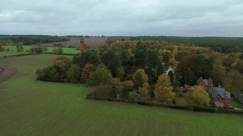 Aerial Drone View of Historic Pumping Station Surrounded by Autumn Forest and Fall Colours in Near