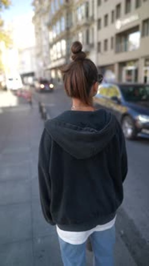 Stylish Woman Standing on City Sidewalk