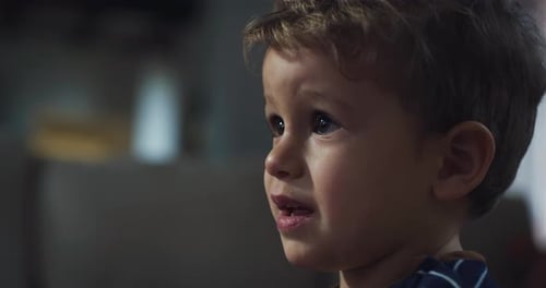 Close Up Portrait of a Little Adorable Child Focused on a Screen. Macro Shot Happy Inf