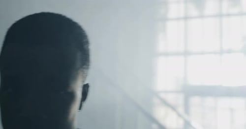 Male Boxer Training in Dark Gym