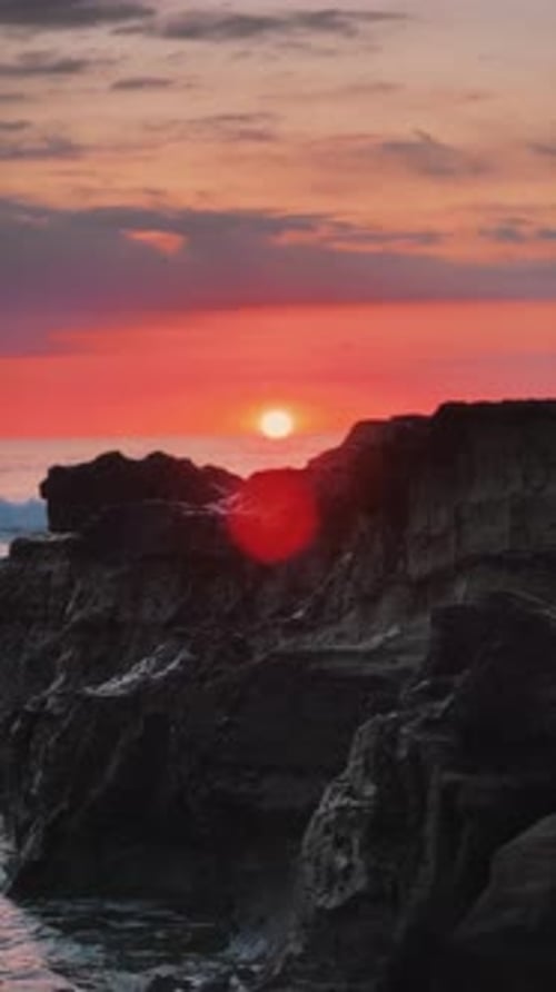Sunset over rocky coastal cliffs