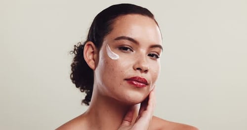 Woman Posing with Moisturizer on Face in Close-up