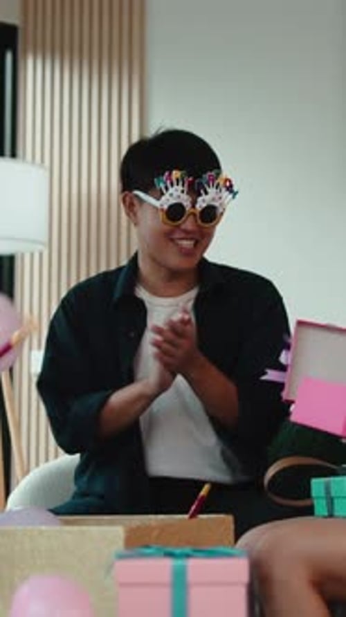 Man Wearing Birthday Glasses Clapping Hands at Party