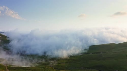 Dense Fog And Cloud Creeping Over Mountain Plateau At Sunset