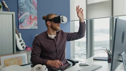 Modern Man Exploring Virtual Reality in Home Office. Young Freelancer Using VR