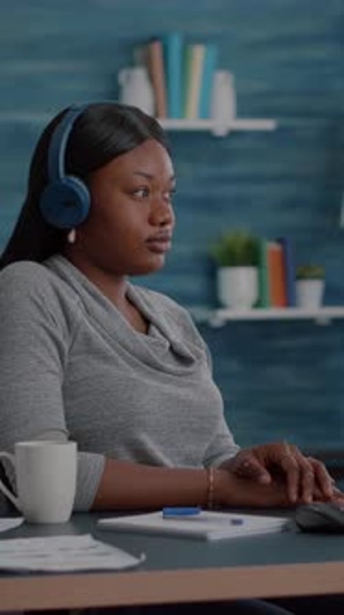 Vertical Video Student with Black Skin Having Headphone Puts Listening Online Univeristy Course