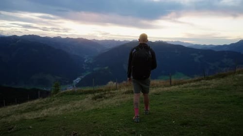 Man Walking And Gazing At Austria Breathtaking Mountains