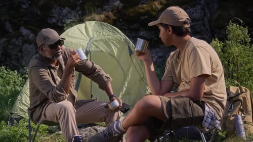 People Camping and Drinking in a Wooded Area