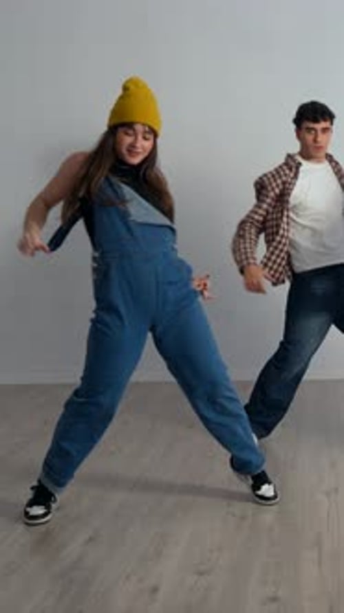 Energetic dancers performing choreography in studio