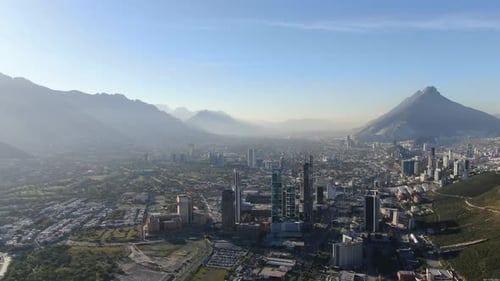 Breathtaking Misty Mountain Valley Overlooking a Modern Urban City Skyline
