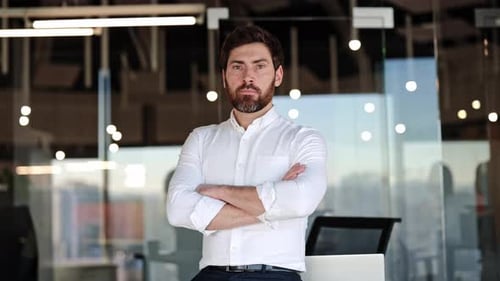 Confident Businessman with Folded Arms in Modern Office A Portrait of Success