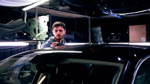 the Car Mechanic at a Service Station Doing the Final Polishing to Shine