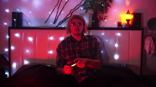 Young Adult Playing Video Game at Night