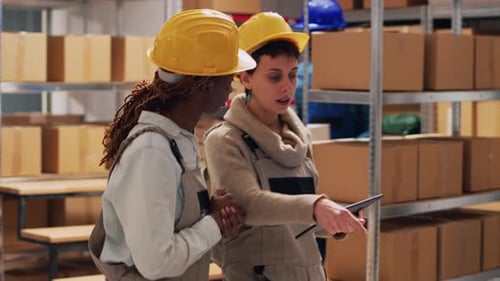 Female Supervisors in Depot Using Digital Tablet to Work