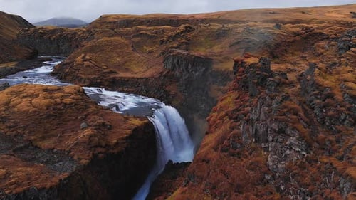 Aerial Waterfall Drops Into Volcanic Canyon in Iceland Highlands