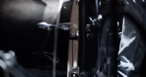 Crop Drummer Pushing Bass Pedals on Stage During Rehearsal
