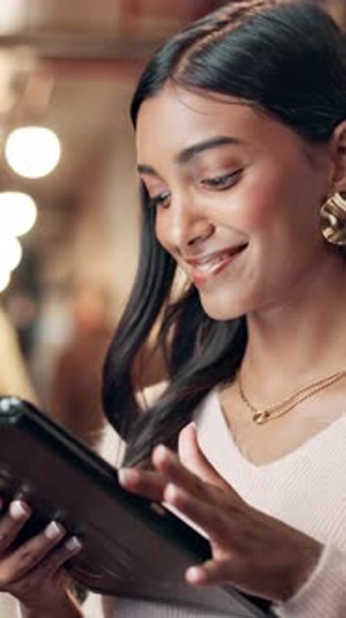 Young Woman Using Tablet Device in Public Setting
