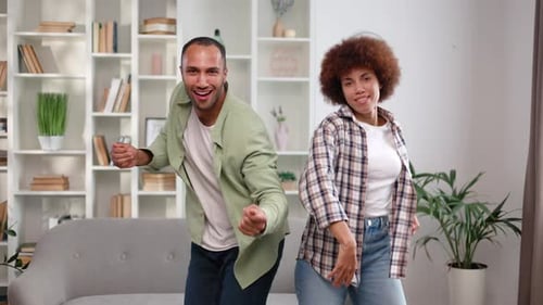 Front View of Funky Man and Woman Making Disco Party During Daytime at Home