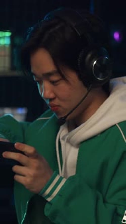 Excited Gamer Celebrates Mobile Game Victory Indoors