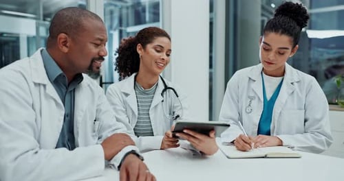 Medical Team Examining X-Ray on Tablet