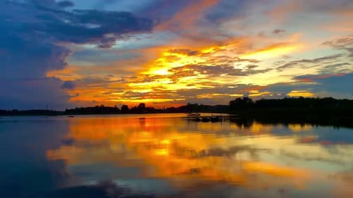 The beautiful sunset over the calm waters of the lake makes for a perfect view